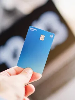 Someone holding a Capital One Platinum Secured Credit Card.