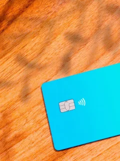 A Self Visa Secured Credit Card on the table.