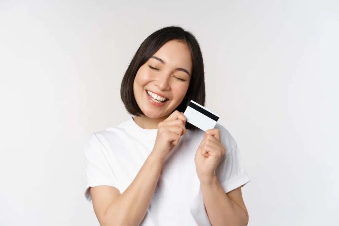 A woman happy using her Mission Lane Visa credit card.