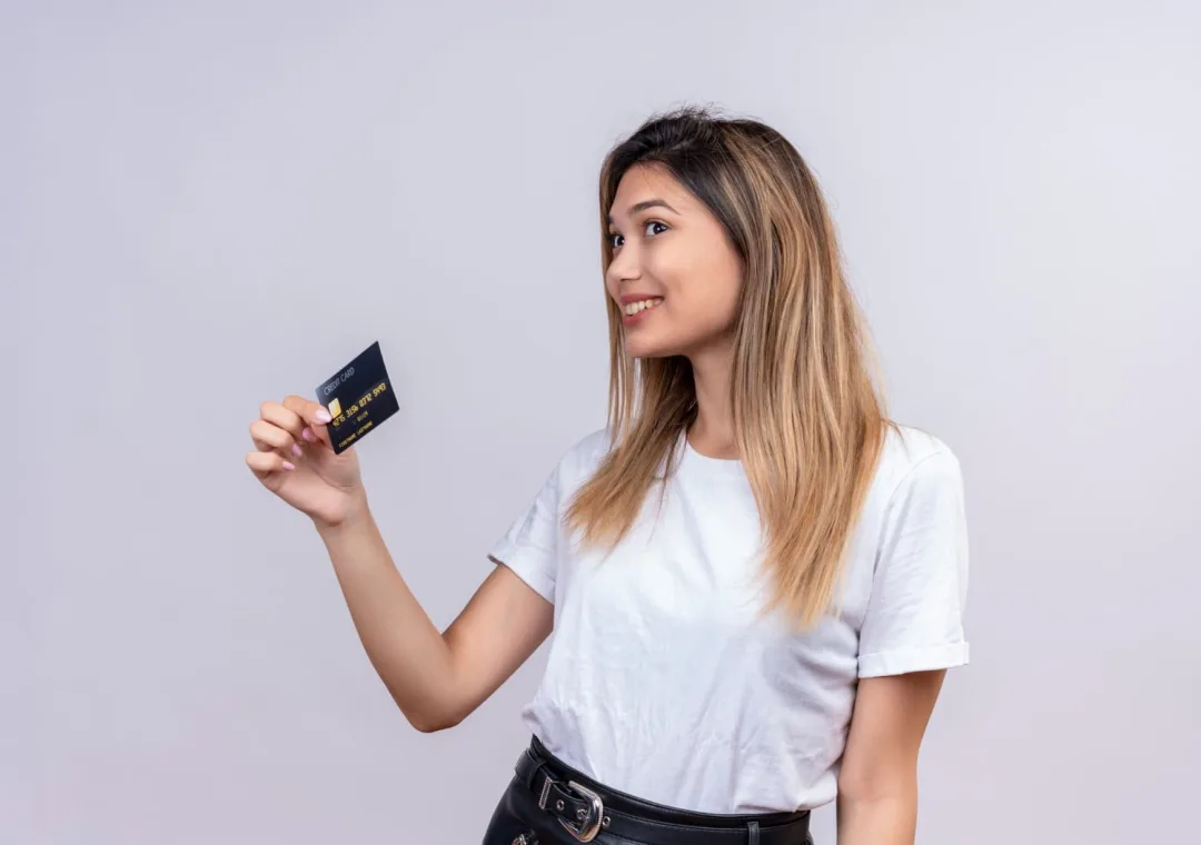 A girl holding her Aeroplan Credit Card.