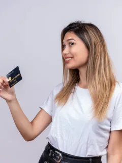A girl holding her Aeroplan Credit Card.