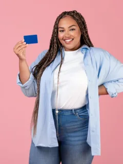 A girl holding her Chase Freedom Unlimited credit card.