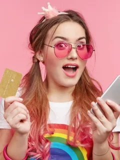 Young woman holding her Discover it Student Cash Back.