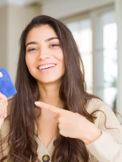 A girl holding her United Explorer Card.