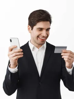 A guy holding his Citi Premier Card.