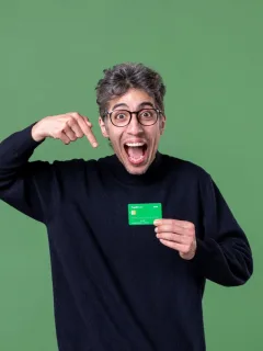 A man holding a Chime Credit Builder Secured Visa credit card.
