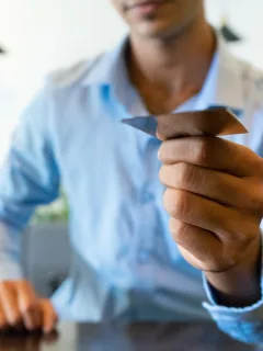 A man holding a Revenued Business Card.