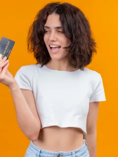 A girl holding her Wells Fargo Active Cash credit card.