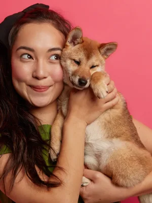 Woman holding her dog after using the Pet Insurance.