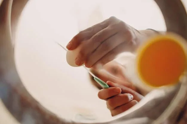 A close-up of a hand gently dabbing a small amount of liquid concealer under an eye with a ring finger, showcasing blendability and light application.