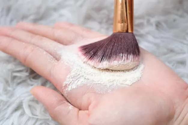 A hand holding a powder brush delicately applying translucent setting powder onto a model's face, illustrating technique and product application.