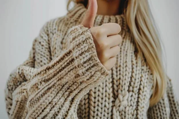 A close-up of a person's hands feeling the texture of a high-quality cashmere sweater, illustrating the concept of material excellence and durability.