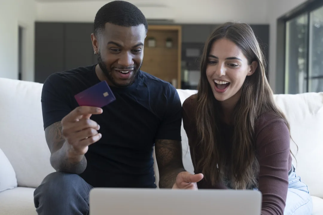 Couple reviewing an online credit card purchase at home