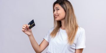 A girl holding her Aeroplan Credit Card.