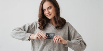 A girl holding her Aeroplan Credit Card.