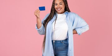 A girl holding her Chase Freedom Unlimited credit card.