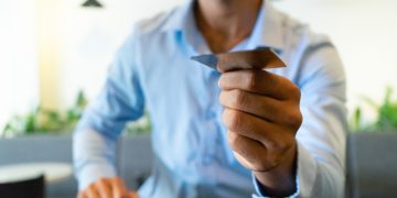 A man holding a Revenued Business Card.