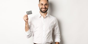 A man holding a Simmons Visa Credit Card.