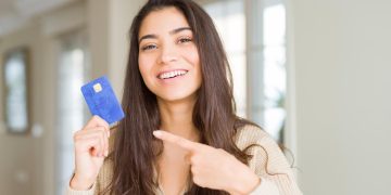 A girl holding her United Explorer Card.