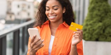 A woman holding her Wells Fargo Health Advantage.