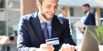 A man using his business credit card.