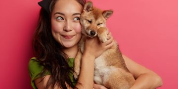 Woman holding her dog after using the Pet Insurance.