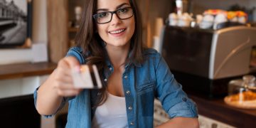 Woman learning Reasons to Use a Credit Card.