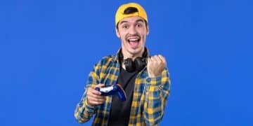 front-view-male-gamer-with-gamepad-playing-video-game-blue-wall