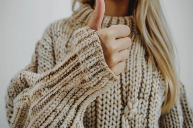 A close-up of a person's hands feeling the texture of a high-quality cashmere sweater, illustrating the concept of material excellence and durability.
