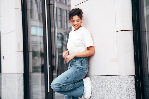 A casual chic outfit featuring a white organic cotton t-shirt, high-waisted ethical denim jeans, and comfortable sustainable sneakers. The setting is a bright, airy coffee shop.