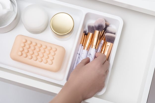 An organized makeup vanity featuring various open concealer tubes and brushes, with a woman's hand reaching for a product, symbolizing preparation and routine.