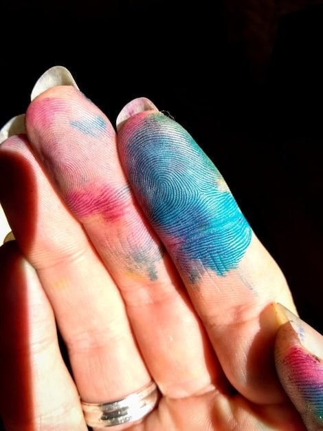A detailed shot of a hand with freshly painted nails in a vibrant color, with a focus on the smooth, glossy finish and perfectly clean edges, showcasing the successful application.