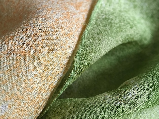 Close-up of a sustainably sourced, gender-neutral textile with a unique texture, perhaps a blend of organic cotton and hemp, showing its quality and natural color, reflecting the industry's material innovation.
