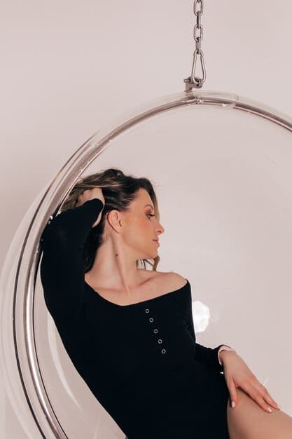 A dynamic photo of a model wearing an oversized, abstract silver cuff bracelet and large, geometric hoop earrings, with a blurred urban backdrop, emphasizing movement and modern style.