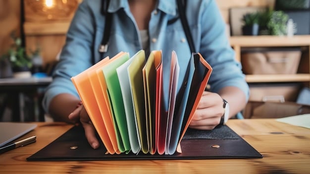 A person organizing physical receipts, warranty cards, and credit card statements in a neat folder, emphasizing organized record-keeping.
