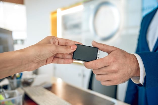 A close-up shot of a credit card being inserted into a payment terminal, with a 