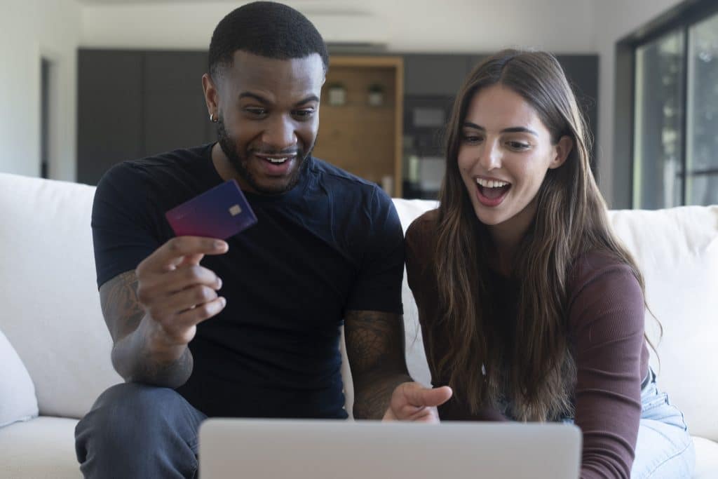 Couple reviewing an online credit card purchase at home