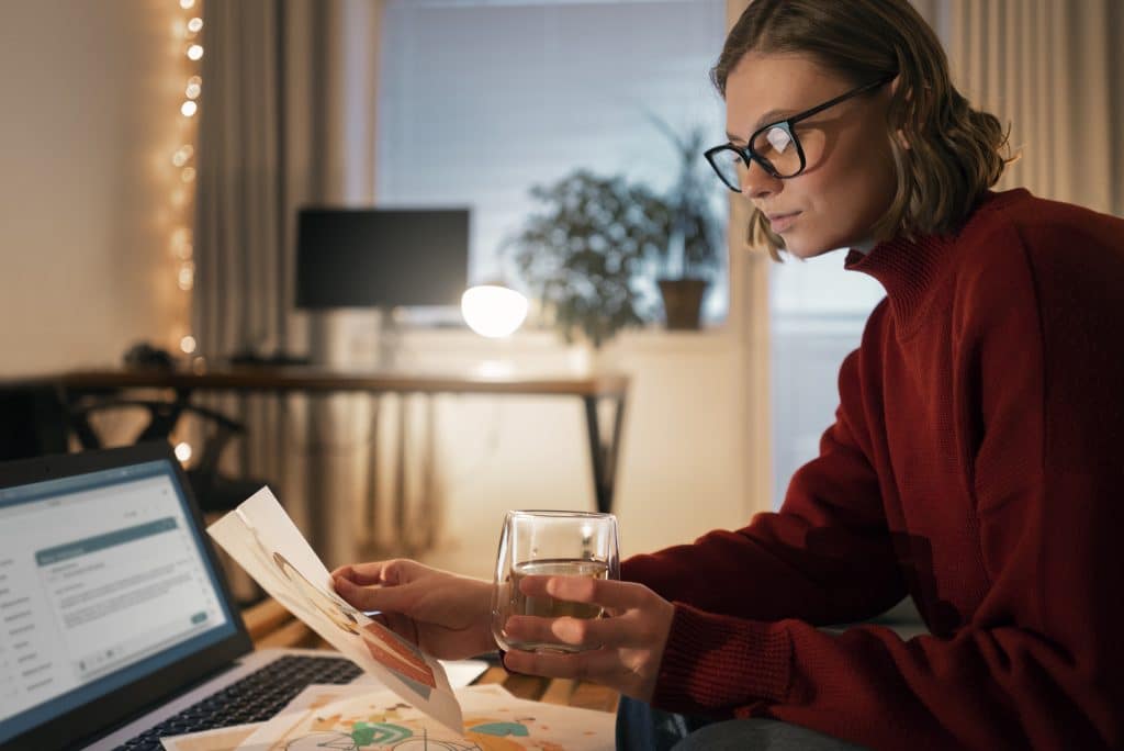 Person using digital financial tools while working from home.